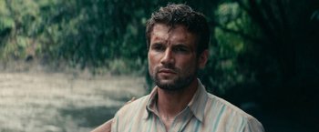 Movie still from “Jungle” (2017), directed by Greg McLean – A person wearing a striped shirt; Close Up shot, Over the shoulder angle