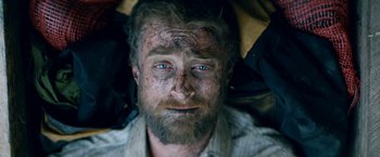 Movie still from “Jungle” (2017), directed by Greg McLean – A person with dirt on his face; Close Up shot, Overhead angle