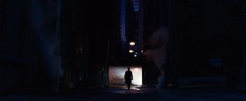 Movie still from “Jupiter Ascending” (2015), directed by Lilly Wachowski – A person walking in the dark near a street light; Extreme Wide shot, High angle