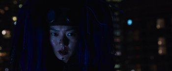 Movie still from “Jupiter Ascending” (2015), directed by Lilly Wachowski – A woman with blue hair is wearing a hat; Close Up shot, Low angle