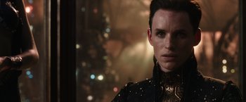 Movie still from “Jupiter Ascending” (2015), directed by Lilly Wachowski – A person wearing a black jacket; Close Up shot, Over the shoulder angle