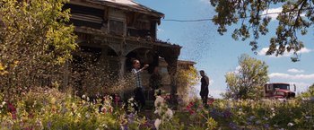 Movie still from “Jupiter Ascending” (2015), directed by Lilly Wachowski – Two people in front of an old house throwing confetti; Extreme Wide shot, Low angle
