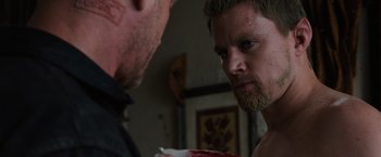 Movie still from “Jupiter Ascending” (2015), directed by Lilly Wachowski – Two men are looking at each other in a room; Close Up shot, Over the shoulder angle
