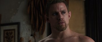 Movie still from “Jupiter Ascending” (2015), directed by Lilly Wachowski – A person with a beard looking at the camera; Close Up shot, Over the shoulder angle