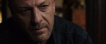 Movie still from “Jupiter Ascending” (2015), directed by Lilly Wachowski – A man's face with a sad look on his face; Close Up shot, Over the shoulder angle