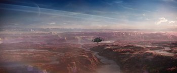 Movie still from “Jupiter Ascending” (2015), directed by Lilly Wachowski – An image of an airplane flying in the sky over the mountains; Extreme Wide shot, High angle