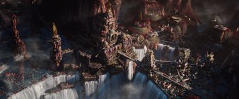Movie still from “Jupiter Ascending” (2015), directed by Lilly Wachowski – A painting of a waterfall with a castle on top of it; Extreme Wide shot, High angle