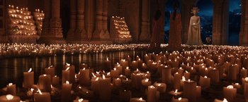 Movie still from “Jupiter Ascending” (2015), directed by Lilly Wachowski – Many lit candles are in the middle of the floor; Extreme Wide shot, High angle