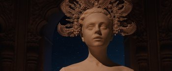 Movie still from “Jupiter Ascending” (2015), directed by Lilly Wachowski – A statue of a woman with a crown on her head; Close Up shot, Low angle