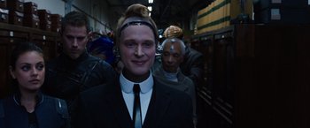 Movie still from “Jupiter Ascending” (2015), directed by Lilly Wachowski – A man in a black suit and a man in a black suit and a man in a white shirt and a man in a black suit and a; Close Up shot, Over the shoulder angle