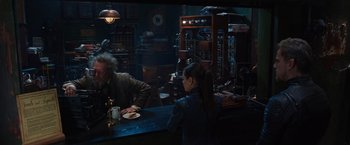 Movie still from “Jupiter Ascending” (2015), directed by Lilly Wachowski – A man and a woman sitting at a table; Medium shot, Over the shoulder angle