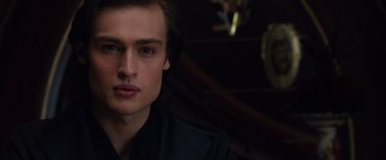 Movie still from “Jupiter Ascending” (2015), directed by Lilly Wachowski – A person wearing a black shirt; Close Up shot, Over the shoulder angle