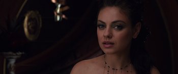 Movie still from “Jupiter Ascending” (2015), directed by Lilly Wachowski – A beautiful woman wearing a necklace and looking at the camera; Close Up shot, Overhead angle