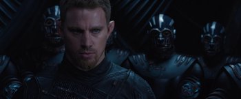 Movie still from “Jupiter Ascending” (2015), directed by Lilly Wachowski – A person wearing a helmet; Close Up shot, Over the shoulder angle