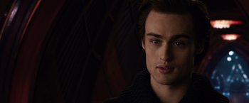 Movie still from “Jupiter Ascending” (2015), directed by Lilly Wachowski – A young man's face in the dark; Close Up shot, Over the shoulder angle