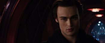 Movie still from “Jupiter Ascending” (2015), directed by Lilly Wachowski – A person wearing a black sweater; Close Up shot, Over the shoulder angle