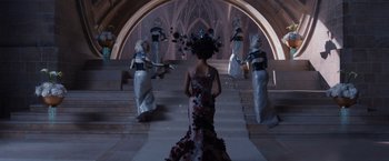 Movie still from “Jupiter Ascending” (2015), directed by Lilly Wachowski – A group of women dressed up in costumes; Wide shot, Over the shoulder angle