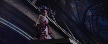 Movie still from “Jupiter Ascending” (2015), directed by Lilly Wachowski – A woman in a dress standing on a staircase; Wide shot, Low angle