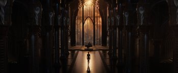 Movie still from “Jupiter Ascending” (2015), directed by Lilly Wachowski – A man is standing in front of a large cathedral; Extreme Wide shot, Low angle