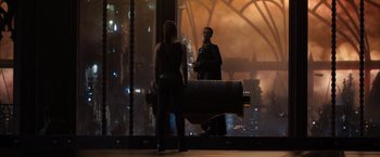 Movie still from “Jupiter Ascending” (2015), directed by Lilly Wachowski – A man and a woman standing in front of a window; Wide shot, Over the shoulder angle