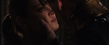 Movie still from “Jupiter Ascending” (2015), directed by Lilly Wachowski – A person with a hand on her face; Close Up shot, Over the shoulder angle