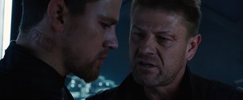 Movie still from “Jupiter Ascending” (2015), directed by Lilly Wachowski – Two men looking at one another in the dark; Close Up shot, Over the shoulder angle