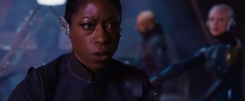 Movie still from “Jupiter Ascending” (2015), directed by Lilly Wachowski – A person wearing a black jacket; Close Up shot, Low angle