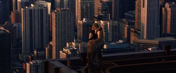 Movie still from “Jupiter Ascending” (2015), directed by Lilly Wachowski – A man and a woman kissing on top of a skyscraper; Wide shot, Overhead angle