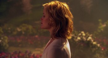 Movie still from “Just Like Heaven” (2005), directed by Mark Waters – A woman standing in front of a bush with flowers in the background; Close Up shot, Over the shoulder angle