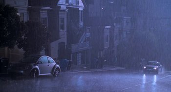 Movie still from “Just Like Heaven” (2005), directed by Mark Waters – A car parked on the side of the road in the rain; Extreme Wide shot, High angle