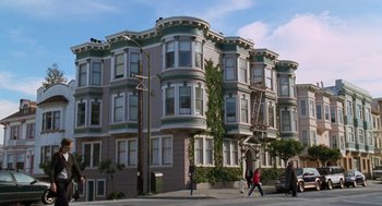 Movie still from “Just Like Heaven” (2005), directed by Mark Waters – People walking on the sidewalk in front of an apartment building; Extreme Wide shot, Low angle