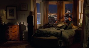 Movie still from “Just Like Heaven” (2005), directed by Mark Waters – A woman standing in a bedroom next to a window; Wide shot, High angle