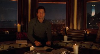 Movie still from “Just Like Heaven” (2005), directed by Mark Waters – A man sitting in front of a window with candles; Medium shot, High angle