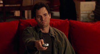 Movie still from “Just Like Heaven” (2005), directed by Mark Waters – A man sitting on a couch holding a remote control; Medium shot, High angle