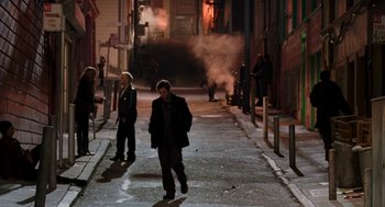 Movie still from “Just Like Heaven” (2005), directed by Mark Waters – A group of people walking down a street at night; Wide shot, High angle