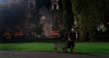Movie still from “Just Like Heaven” (2005), directed by Mark Waters – A man sitting on a bench in front of a church; Extreme Wide shot, High angle