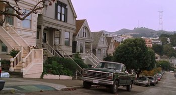 Movie still from “Just Like Heaven” (2005), directed by Mark Waters – A truck parked on the side of the road in front of some houses; Wide shot, High angle