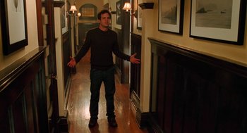 Movie still from “Just Like Heaven” (2005), directed by Mark Waters – A man standing in a hallway with his arms outstretched; Medium shot, High angle