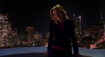 Movie still from “Just Like Heaven” (2005), directed by Mark Waters – A woman standing on top of a building at night with a city in the background; Medium shot, Low angle