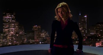 Movie still from “Just Like Heaven” (2005), directed by Mark Waters – A woman standing in front of a city at night; Medium shot, Over the shoulder angle