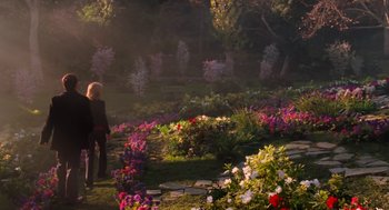 Movie still from “Just Like Heaven” (2005), directed by Mark Waters – A woman is standing in a flower garden; Extreme Wide shot, High angle