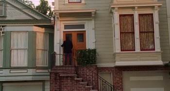 Movie still from “Just Like Heaven” (2005), directed by Mark Waters – A man standing on a porch of an apartment building; Wide shot, High angle