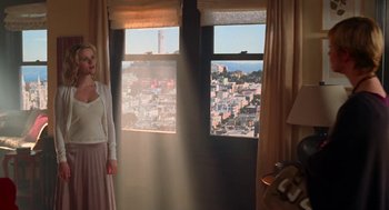 Movie still from “Just Like Heaven” (2005), directed by Mark Waters – A woman standing in front of a window with a view of a city; Wide shot, Low angle