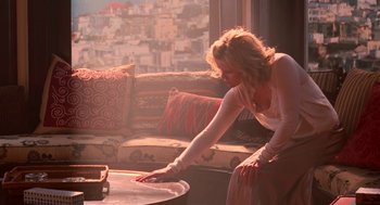 Movie still from “Just Like Heaven” (2005), directed by Mark Waters – A woman leaning over a coffee table in a living room; Wide shot, High angle