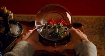 Movie still from “Just Like Heaven” (2005), directed by Mark Waters – A person holding a snow globe in their hands; Extreme Close Up shot, High angle