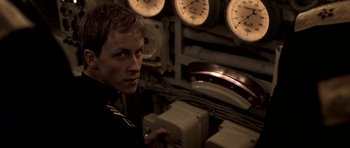 Movie still from “K-19: The Widowmaker” (2002), directed by Kathryn Bigelow – A young man in a uniform in front of a bunch of gauges; Close Up shot, Over the shoulder angle