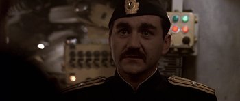 Movie still from “K-19: The Widowmaker” (2002), directed by Kathryn Bigelow – A person wearing a uniform; Close Up shot, Low angle