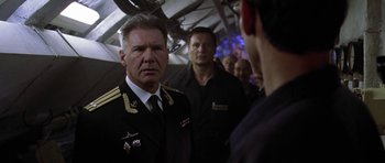 Movie still from “K-19: The Widowmaker” (2002), directed by Kathryn Bigelow – A group of men standing next to each other in a room; Close Up shot, Over the shoulder angle