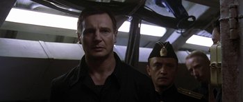 Movie still from “K-19: The Widowmaker” (2002), directed by Kathryn Bigelow – A man standing next to another man wearing a uniform; Close Up shot, Low angle