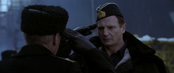 Movie still from “K-19: The Widowmaker” (2002), directed by Kathryn Bigelow – A man in a military uniform saluting another man; Medium shot, Low angle